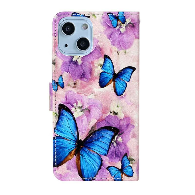 Housse iPhone 13 Mini Papillons Bleus Dans Les Fleurs