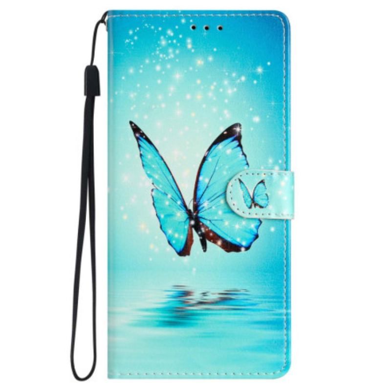 Housse iPhone 15 Papillon Bleu en Vol à Lanière